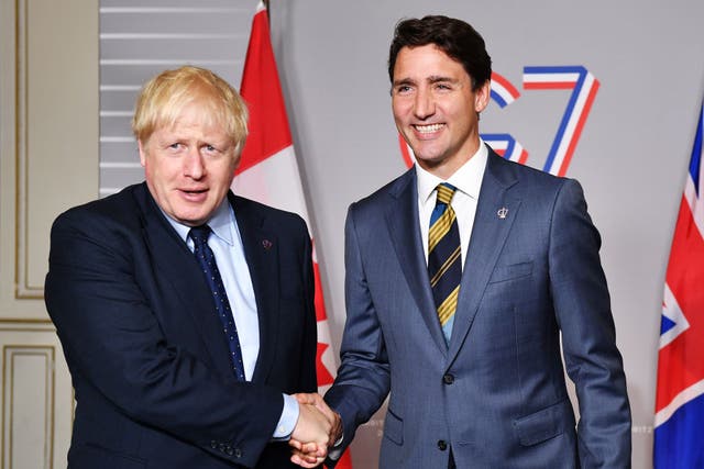 <p>Boris Johnson shakes hands with Justin Trudeau. The UK government intends to upgrade its trade deal with Canada</p>