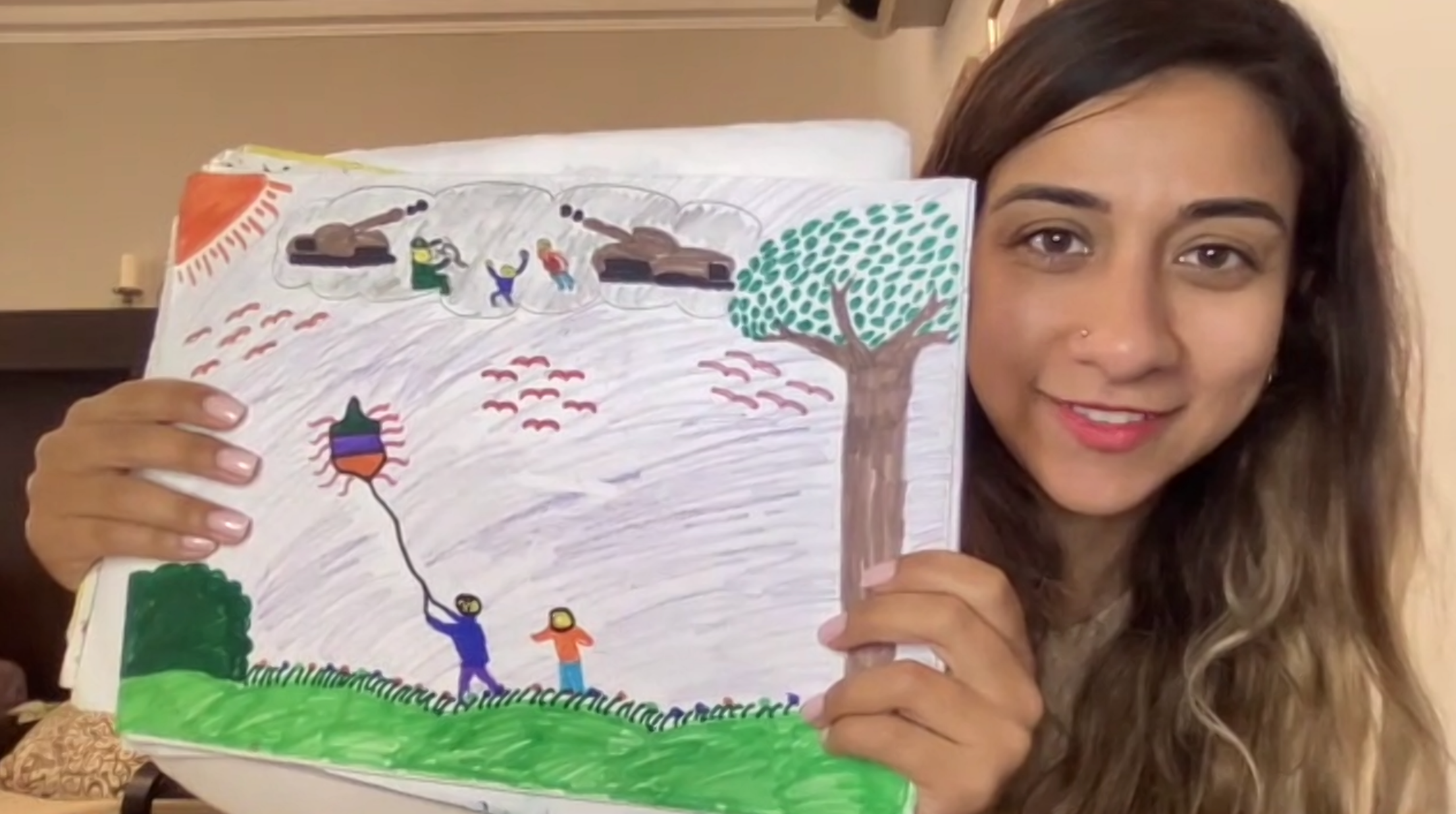 Eman Askar holding a photograph she drew as a kid 21 years ago