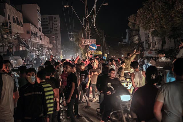 <p>Palestinians in Gaza City celebrate the ceasefire agreement between Israel and Hamas on Friday</p>