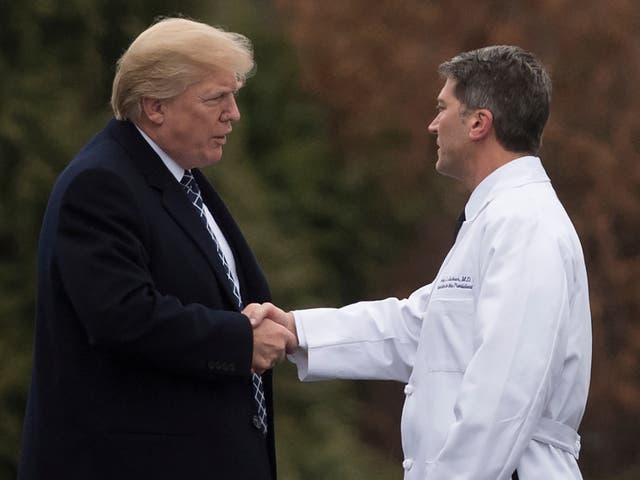 <p>Former president Donald Trump shakes hands with former White House Physician Rear Admiral Dr Ronny Jackson</p>