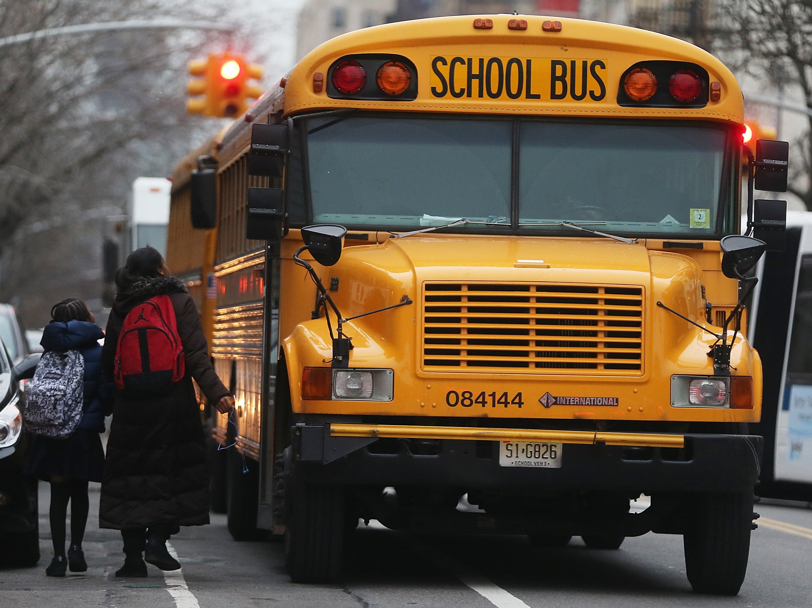 <p>Students walk to board a school bus in Manhattan's East Village on January 15, 2013 in New York City</p>