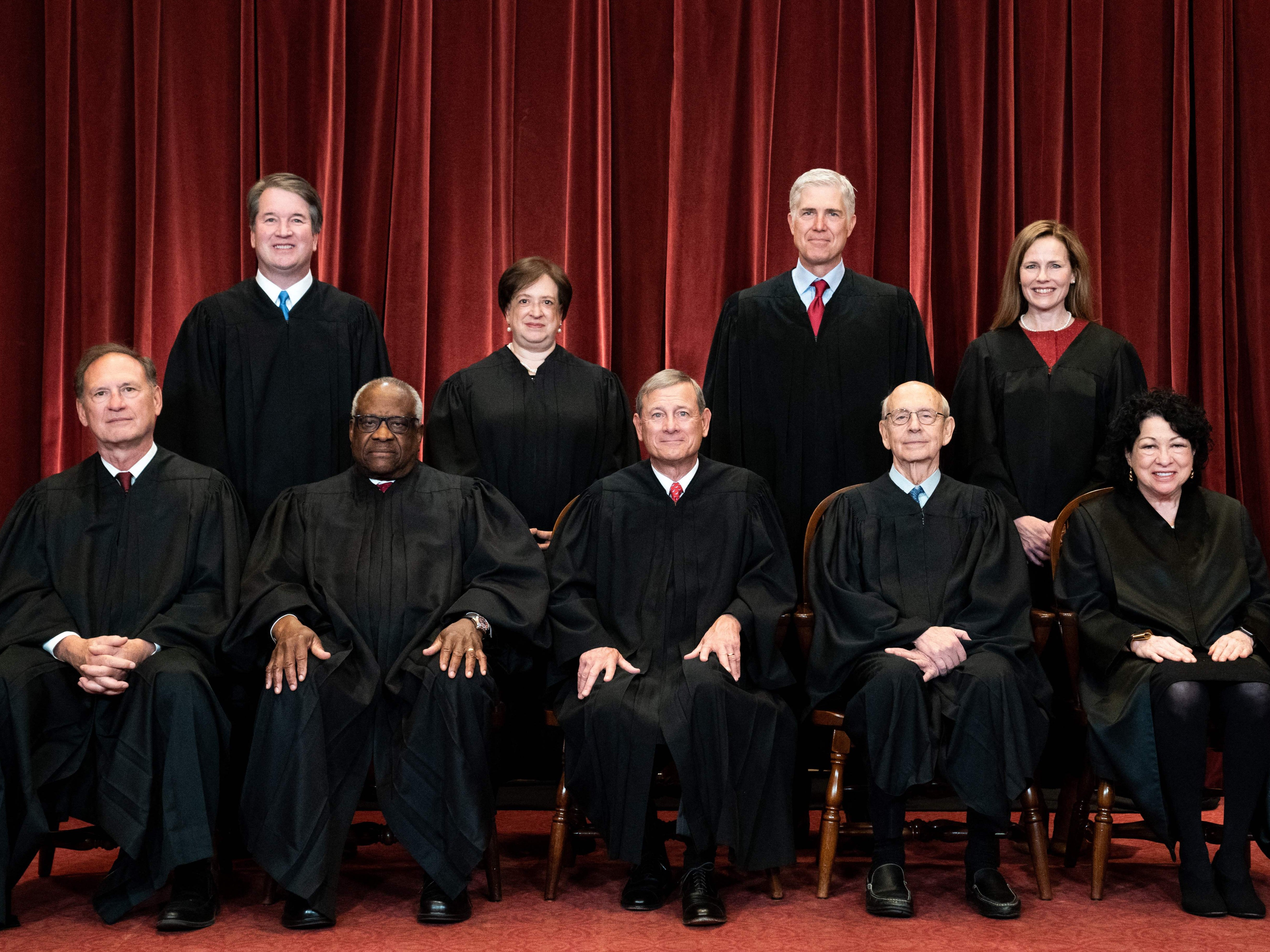 Seated from left: Associate Justice Samuel Alito, Associate Justice Clarence Thomas, Chief Justice John Roberts, Associate Justice Stephen Breyer and Associate Justice Sonia Sotomayor, standing from left: Associate Justice Brett Kavanaugh, Associate Justice Elena Kagan, Associate Justice Neil Gorsuch and Associate Justice Amy Coney Barrett pose during a group photo of the Justices at the Supreme Court in Washington, DC on 23 April 2021