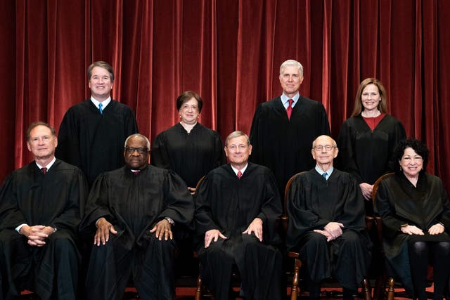 Seated from left: Associate Justice Samuel Alito, Associate Justice Clarence Thomas, Chief Justice John Roberts, Associate Justice Stephen Breyer and Associate Justice Sonia Sotomayor, standing from left: Associate Justice Brett Kavanaugh, Associate Justice Elena Kagan, Associate Justice Neil Gorsuch and Associate Justice Amy Coney Barrett pose during a group photo of the Justices at the Supreme Court in Washington, DC on 23 April 2021