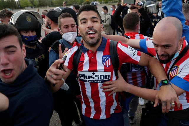 Atletico Madrid’s Luis Suarez celebrates with supporters after clinching the LaLiga title