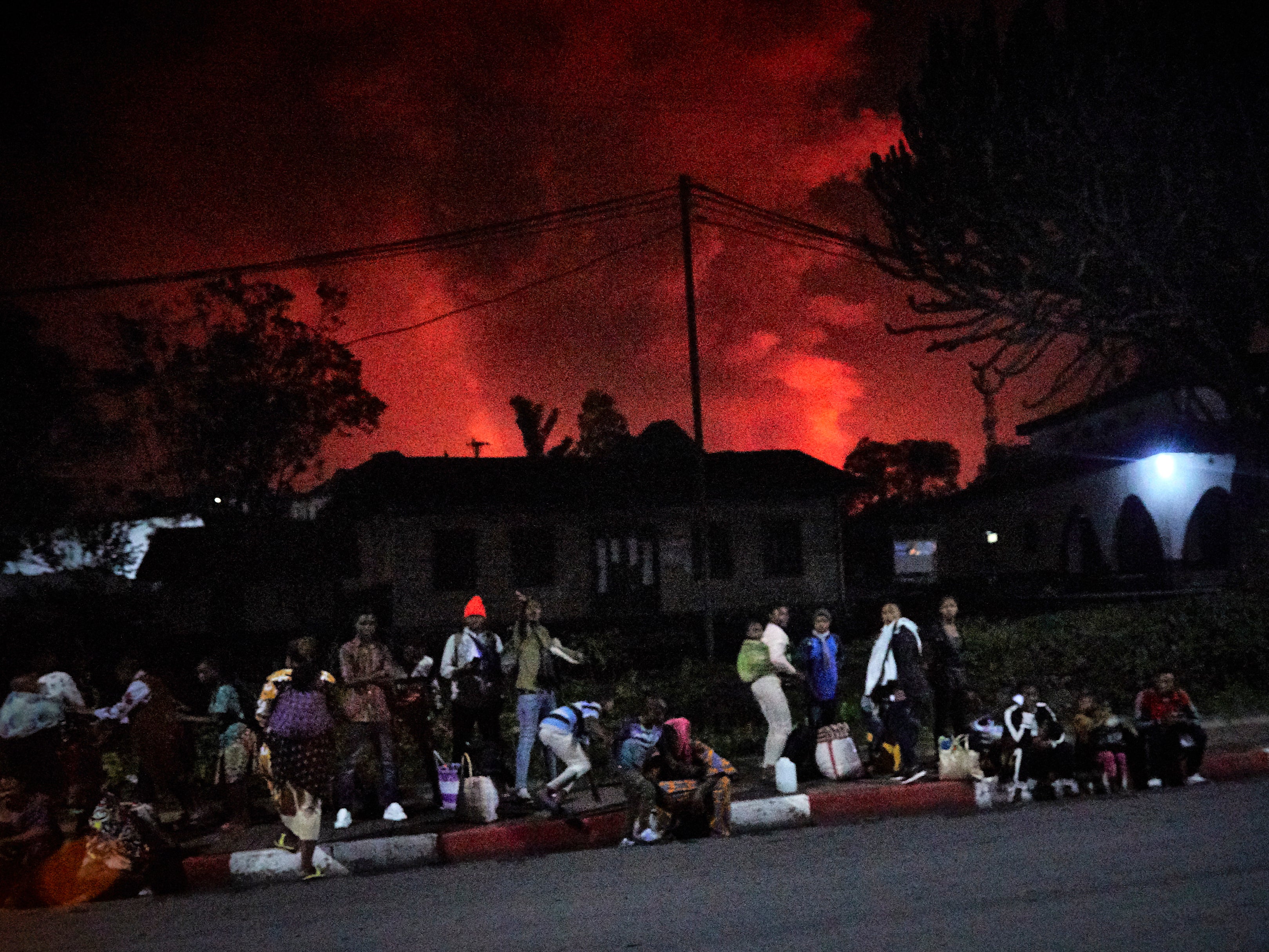 Congolese residents of Goma flee from Mount Nyiragongo volcano as it erupts