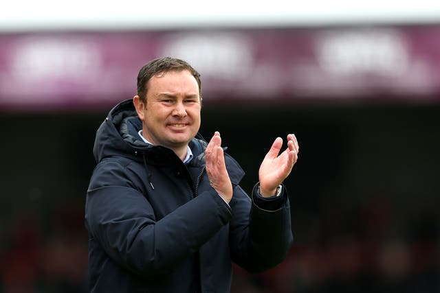 Morecambe manager Derek Adams applauds the fans after reaching the play-off final