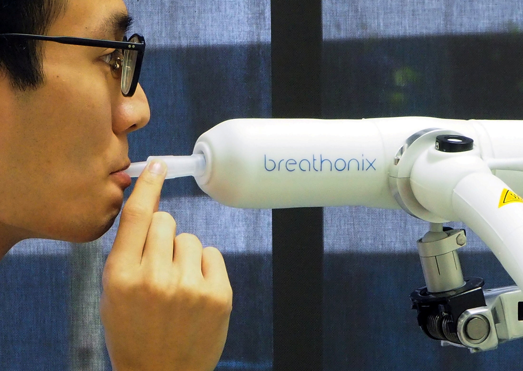 A staff member demonstrates the usage of Breathonix breathalyzer test at their laboratory in Singapore on 29 October, 2020