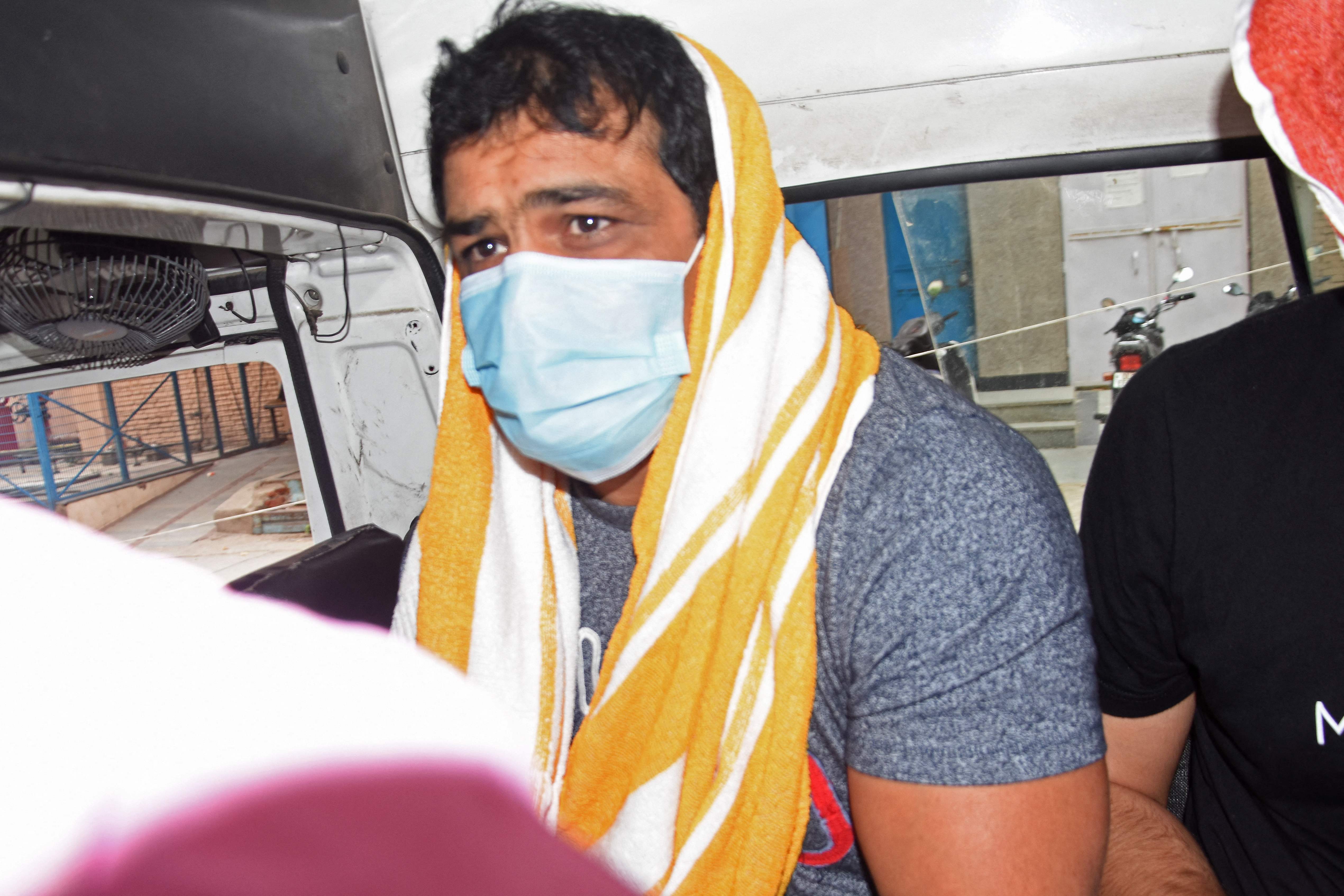 Olympic wrestler Sushil Kumar sits inside a vehicle after his arrest in New Delhi on 23 May, 2021