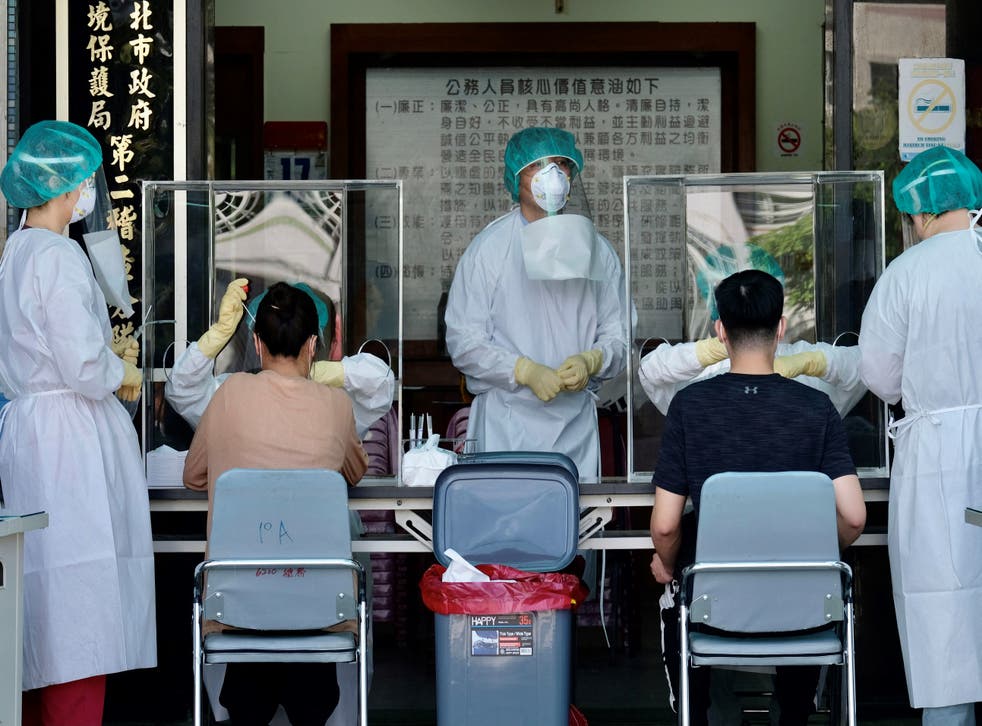 <p>Medical staffers collect samples from local residents during a COVID-19 corona virus testing at the Xindian District in New Taipei City </p>