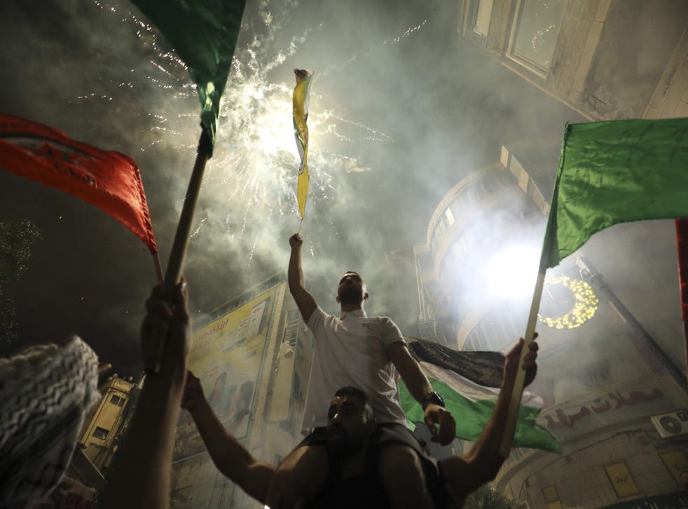 <p>Palestinians celebrate in Ramallah in support of the resistance in Gaza, after the ceasefire was announced</p>
