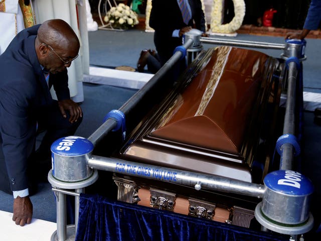 <p>Mourners gather beside the coffin of Zimbabwe’s former president, Robert Mugabe, at his burial site in Kutama</p>
