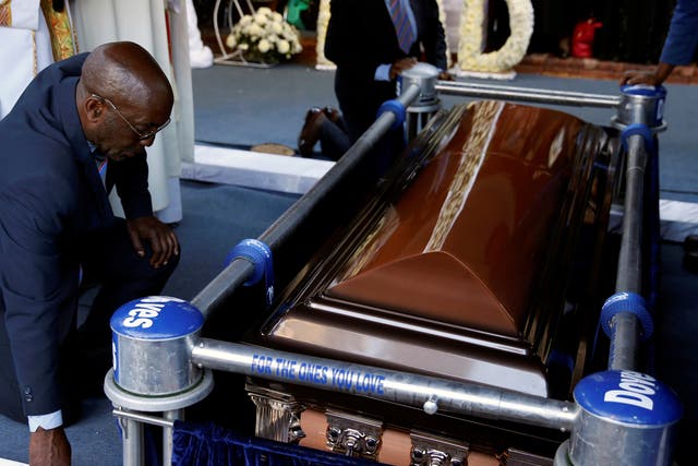 <p>Mourners gather beside the coffin of Zimbabwe’s former president, Robert Mugabe, at his burial site in Kutama</p>