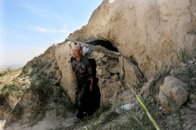 <p>Shepherd Zhu Keming, who is hailed as a hero in China for rescuing six ultramarathon runners when extreme weather hit the area leaving at least 20 dead, showing the cave dwelling where he sheltered the stricken athletes near the city of Baiyin, in China's northwestern Gansu province</p>