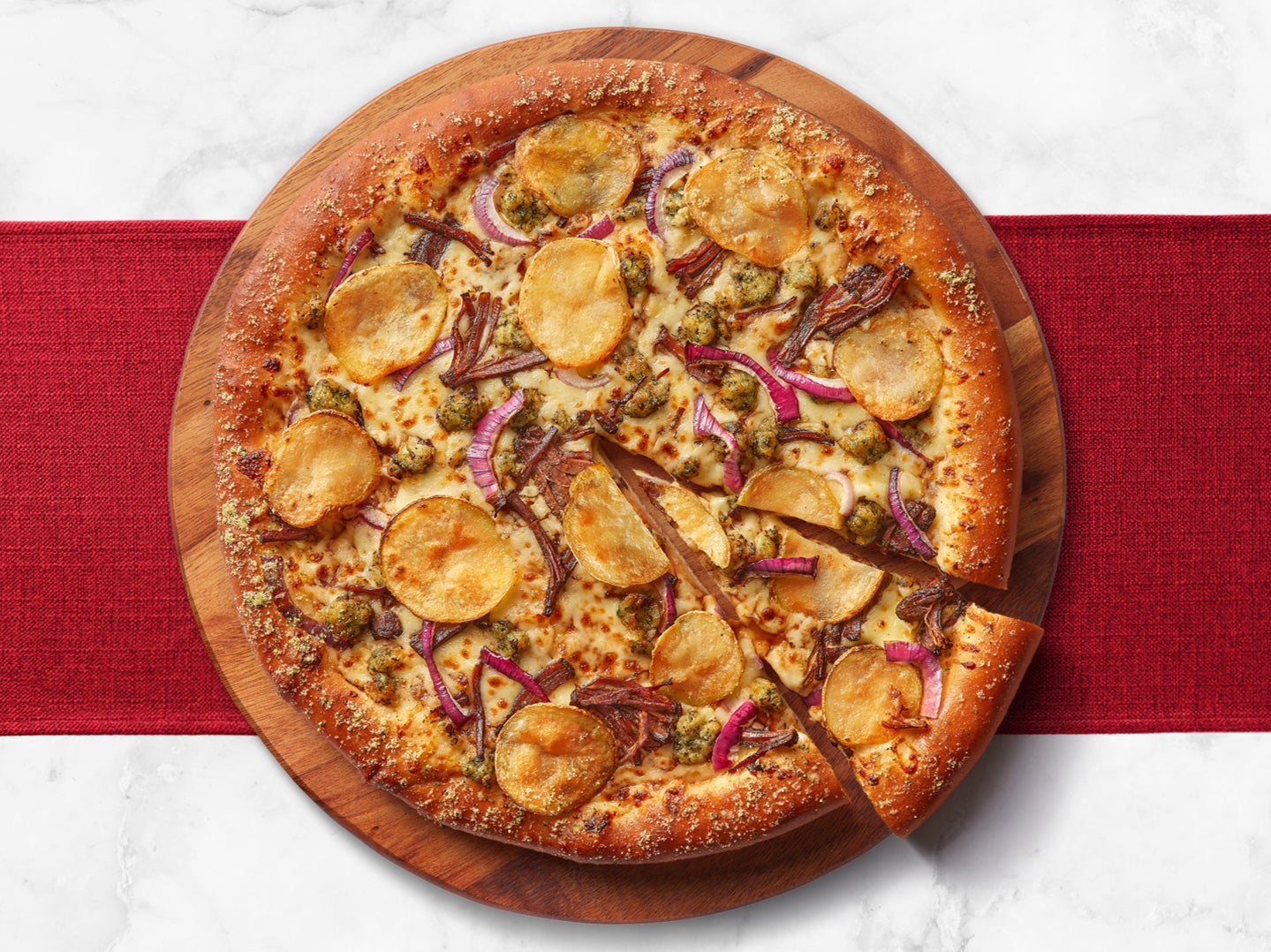 Pizza Hut’s new roast dinner pizza features roast beef, thinly sliced roast potatoes, stuffing and onions on a red wine gravy base
