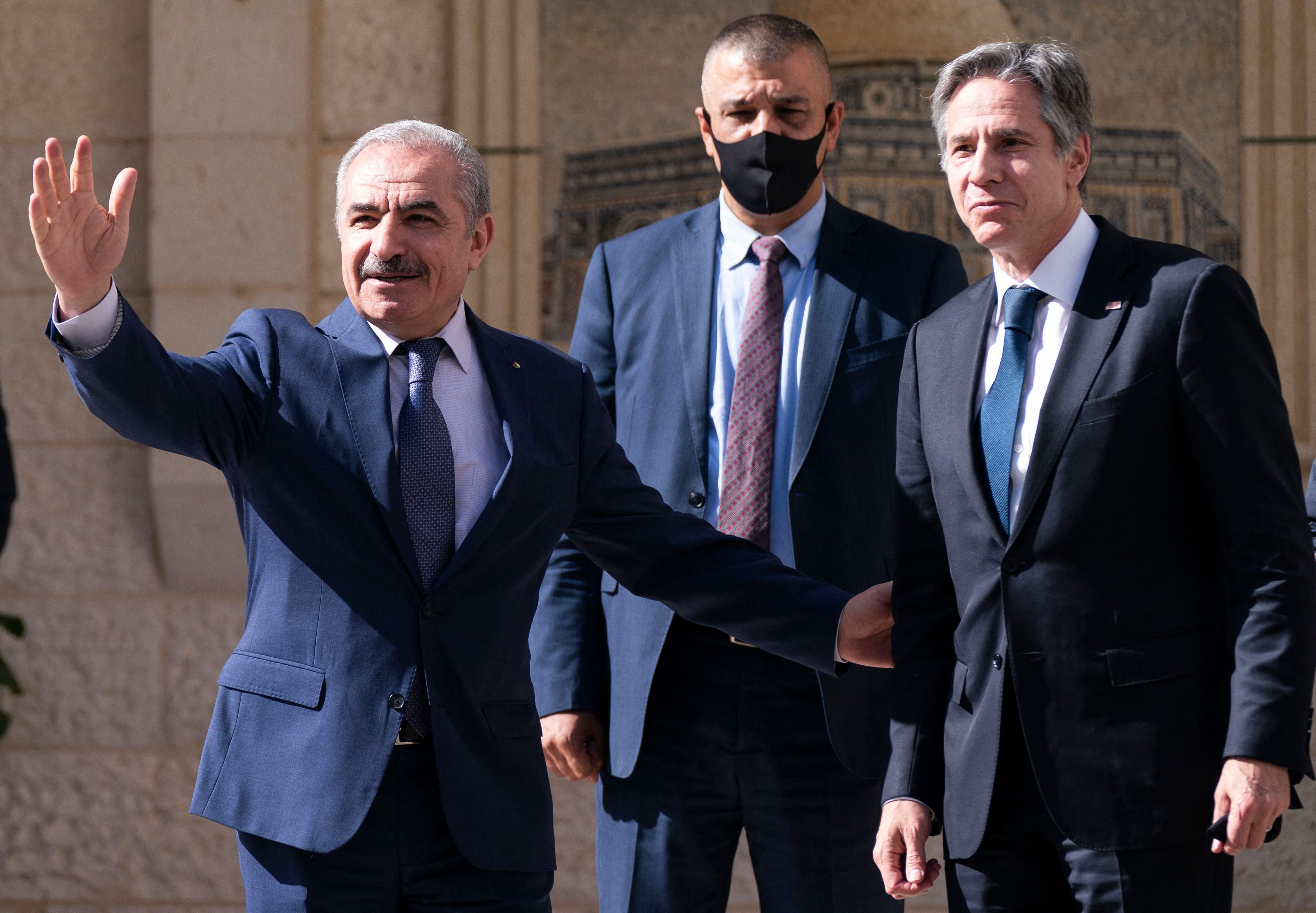 Palestinian prime minister Mohammad Shtayyeh (left), waves as he greets Antony Blinken in Ramallah