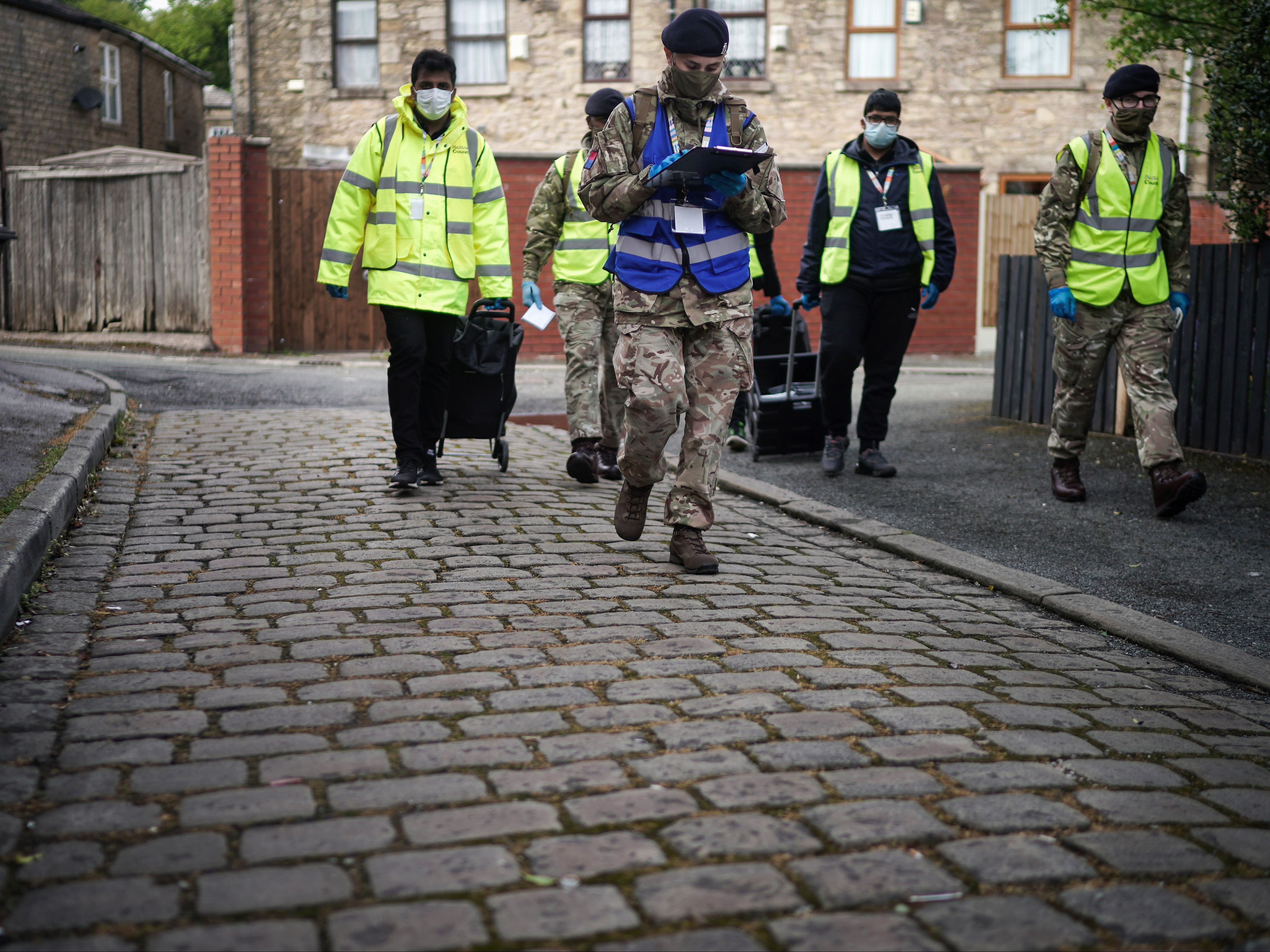 Members of the army help hand out Covid tests in Bolton