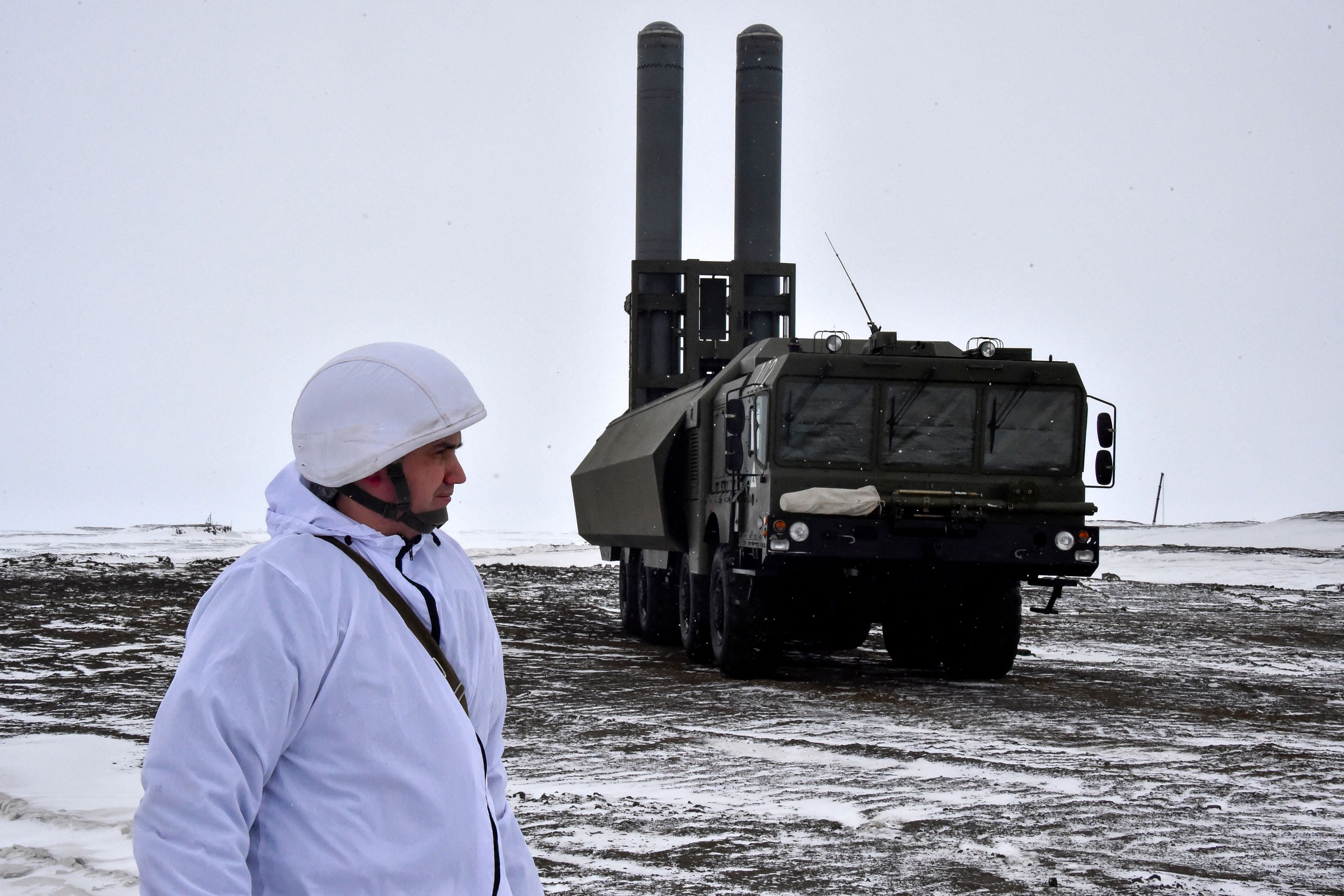 A serviceman stands near a Russian Bastion mobile coastal defence missile system on the island of Alexandra Land