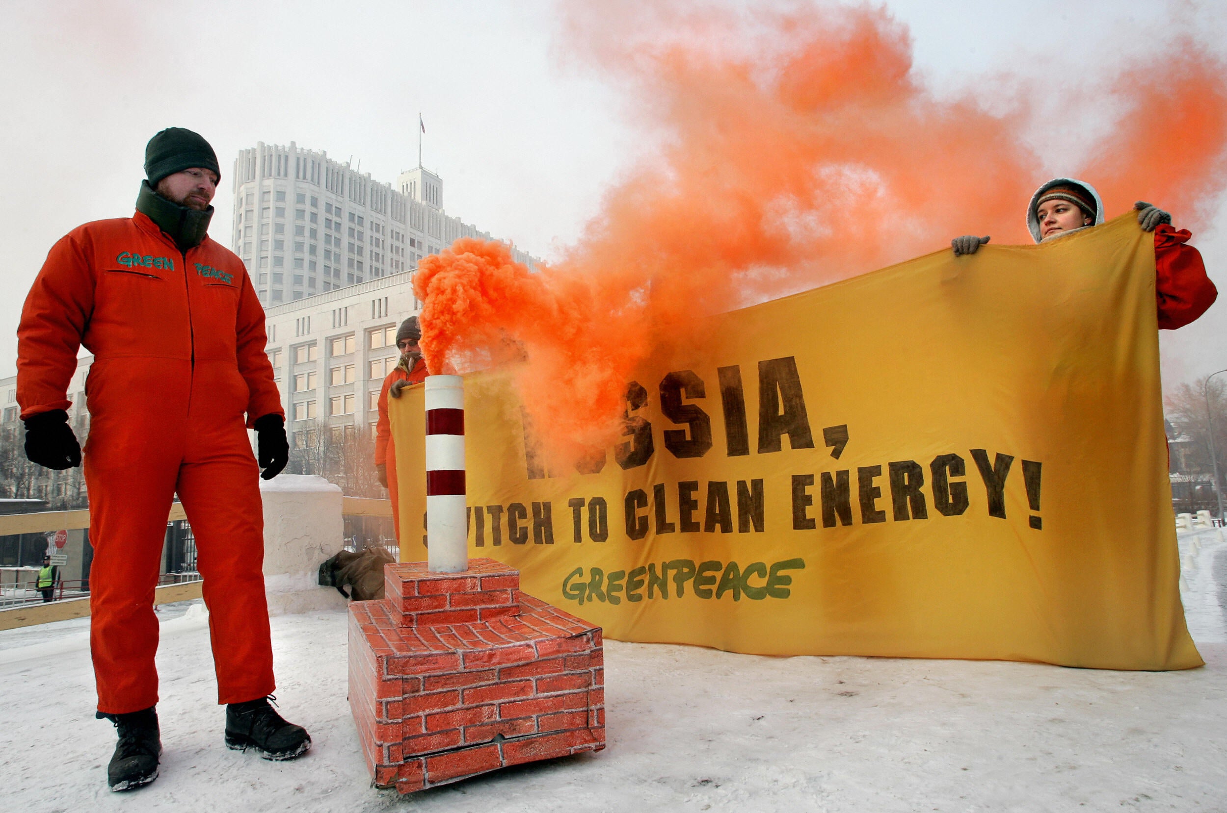 Greenpeace activists light a ‘dirty’ stove during their protest in front of the government building in Moscow