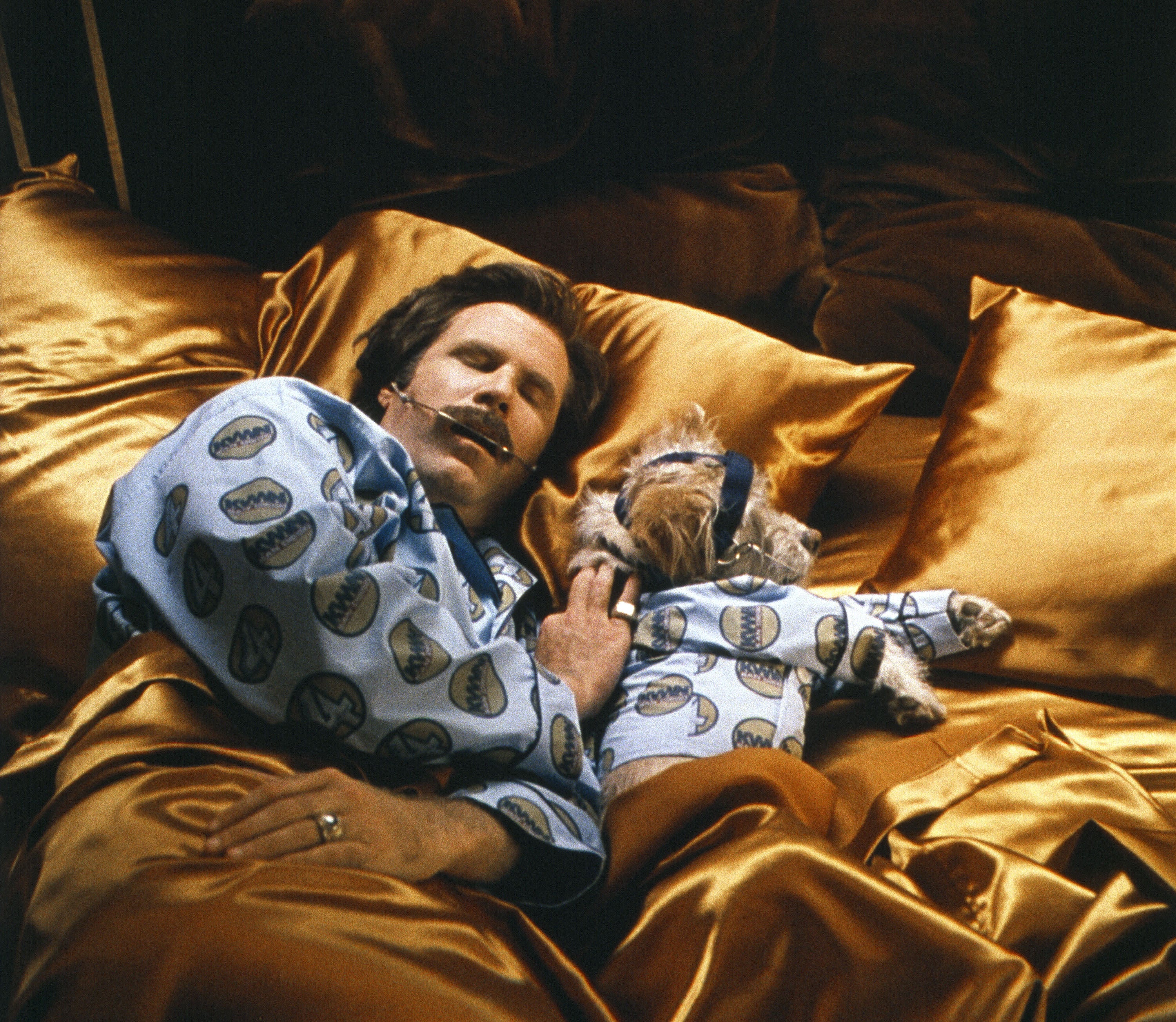 Ron Burgundy (Will Ferrell) and his sidekick Baxter (Peanut) wearig matching pyjamas in ‘Anchorman: The Legend of Ron Burgundy’ in 2004