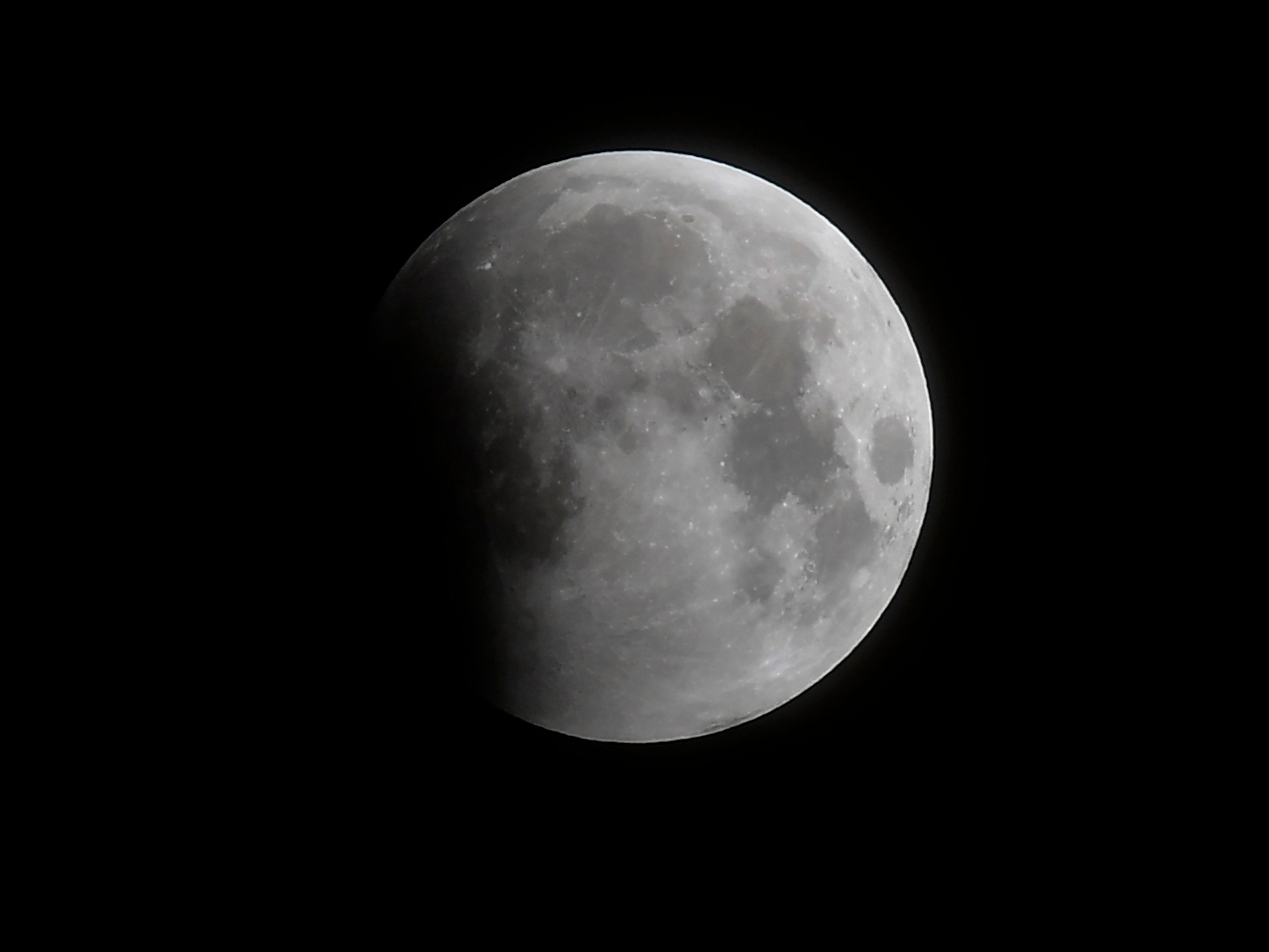 The progression of the eclipse begins with a partial covering of the moon as seen in Santa Monica, California, on Wednesday 26 May 2021