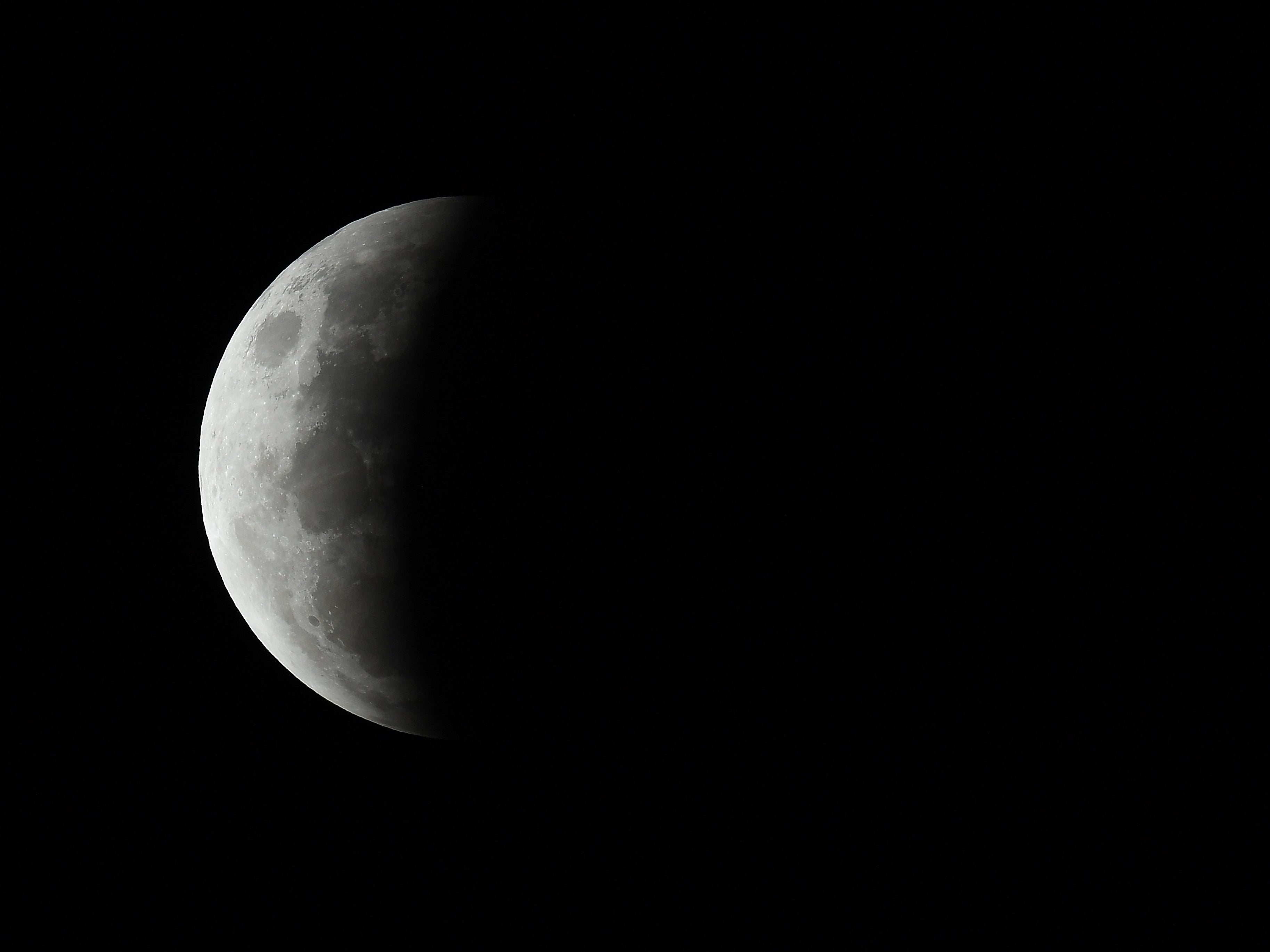 The progression of the eclipse begins with a partial covering of the moon as seen in Sydney, Australia, on Wednesday 26 May 2021
