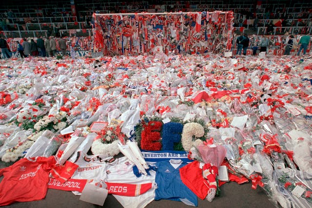 <p>Flower tributes cover the ‘Kop’ at Anfield in Liverpool, on 17 April 1989</p>