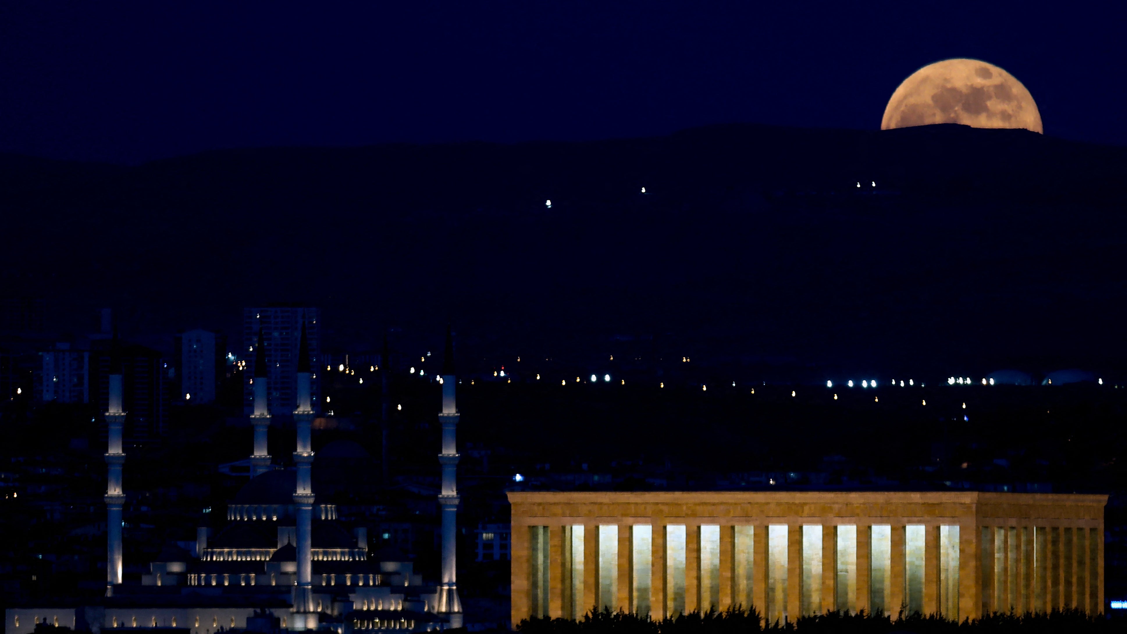 The “Super Blood Moon” rises over the Anitkabir and the Kocatepe Mosque in Ankara, Turkey on the evening of 26 May, 2021