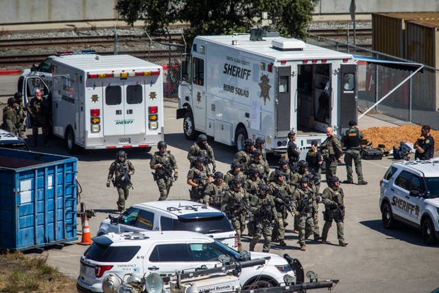<p>Tactical law enforcement officers move through the Valley Transportation Authority (VTA) light-rail yard where a mass shooting occurred on May 26, 2021 in San Jose, California</p>