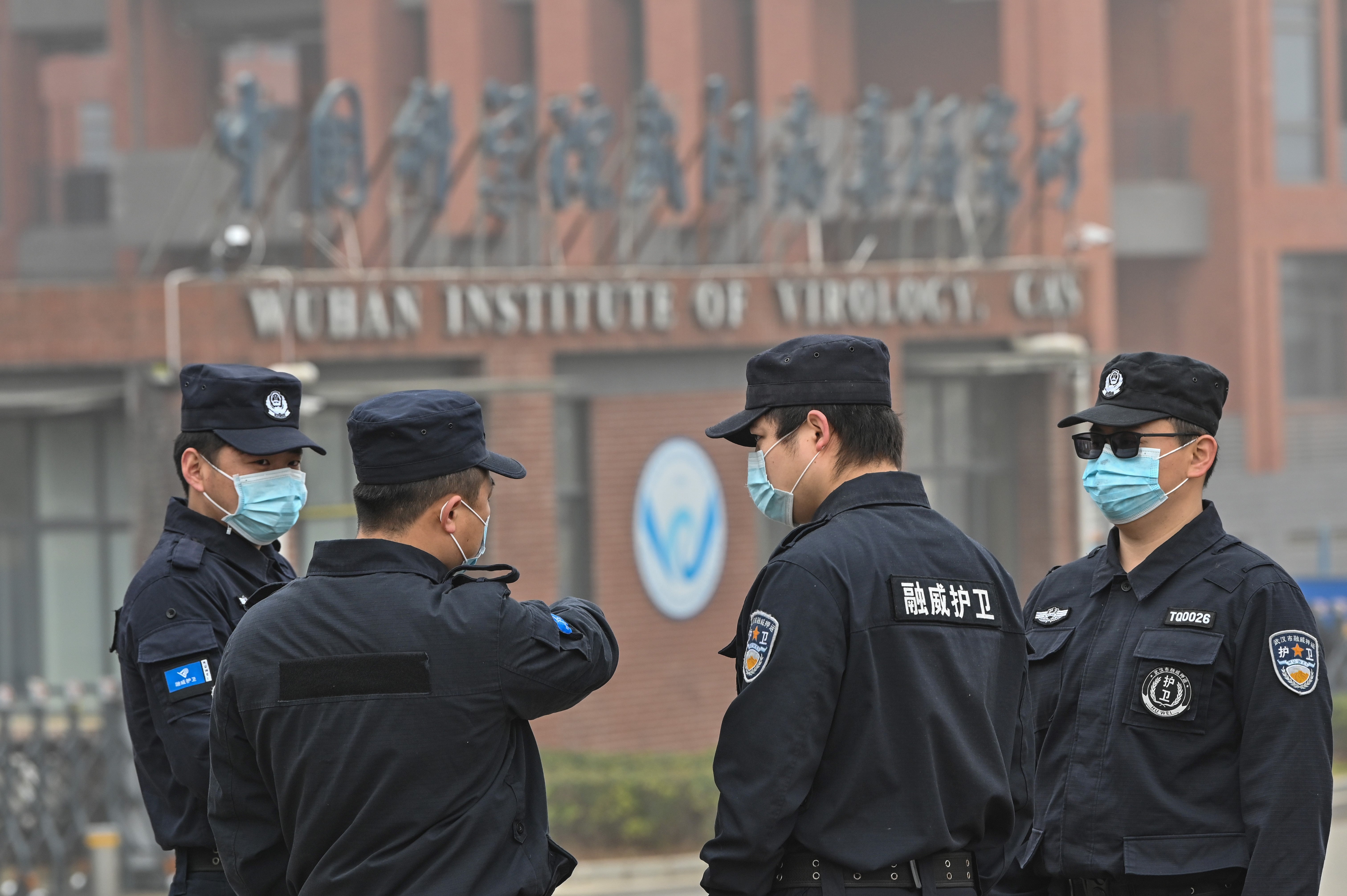 <p>Security personnel stand guard outside the Wuhan Institute of Virology in Wuhan as members of the World Health Organization (WHO) team investigating the origins of the COVID-19 coronavirus make a visit</p>