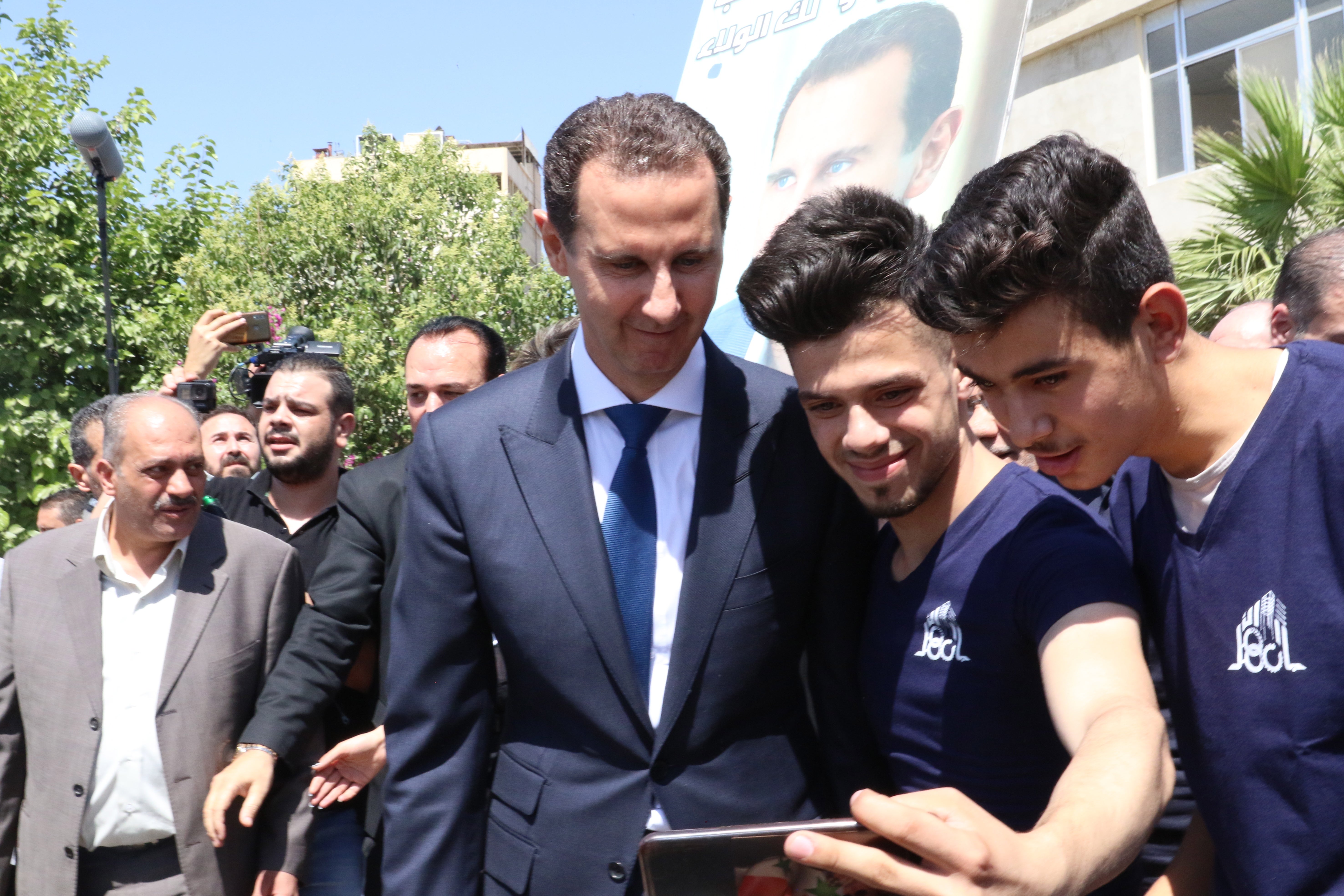 Bashar Assad takes a selfie with supportes in Douma near Damascus after voting in Syrian presidential elections