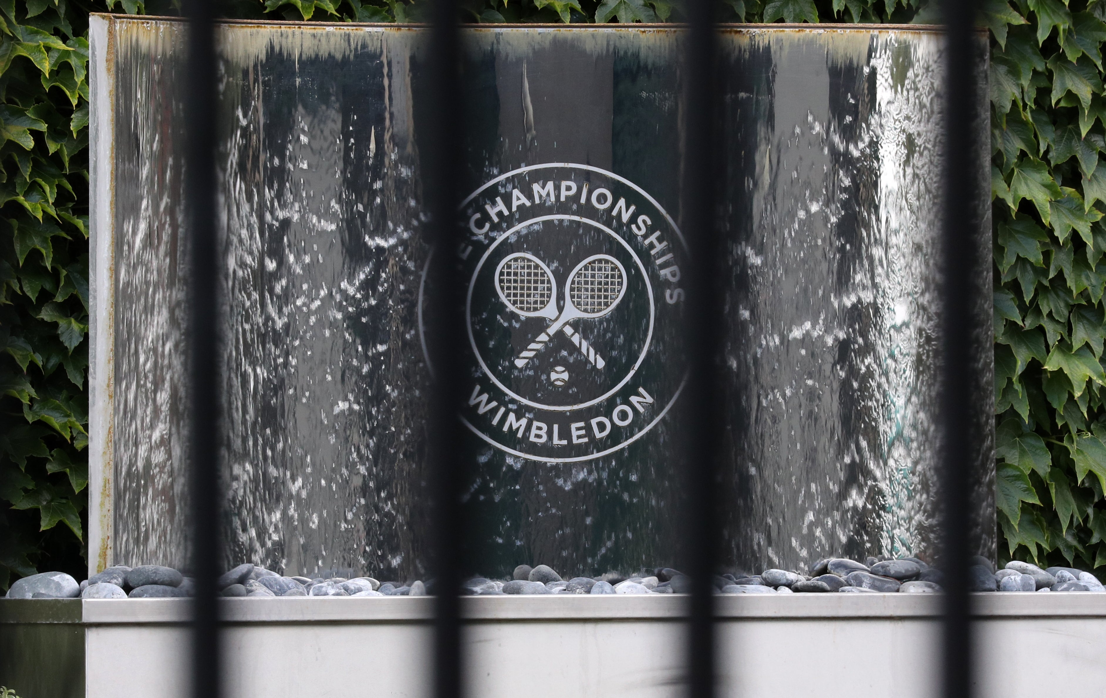 The Wimbledon logo seen through railings