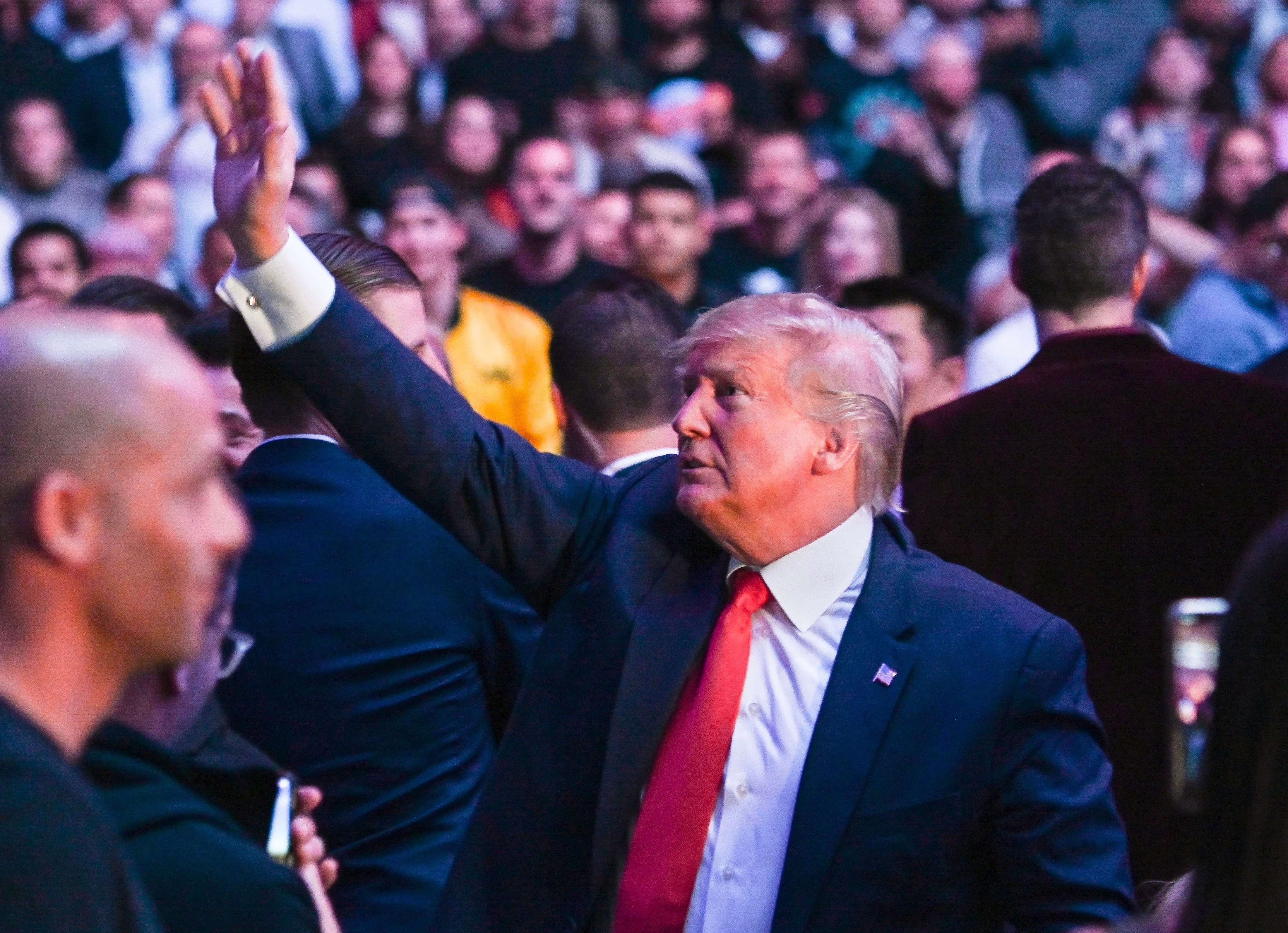 Donald Trump waves to supporters at UFC fight