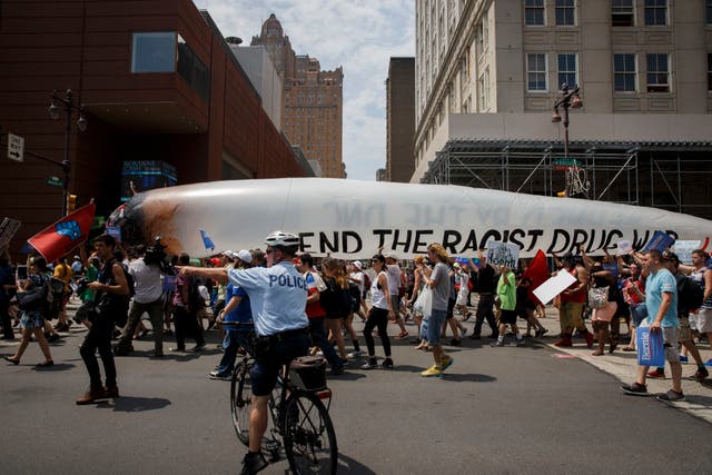 <p>People march with a 51-foot-long marijuana joint protesting the "racist drug war" and holding signs in support of former Democratic presidential candidate Bernie Sanders during a protest at the 2016 Democratic National Convention, July 25, 2016 in Philadelphia, Pennsylvania.   </p>