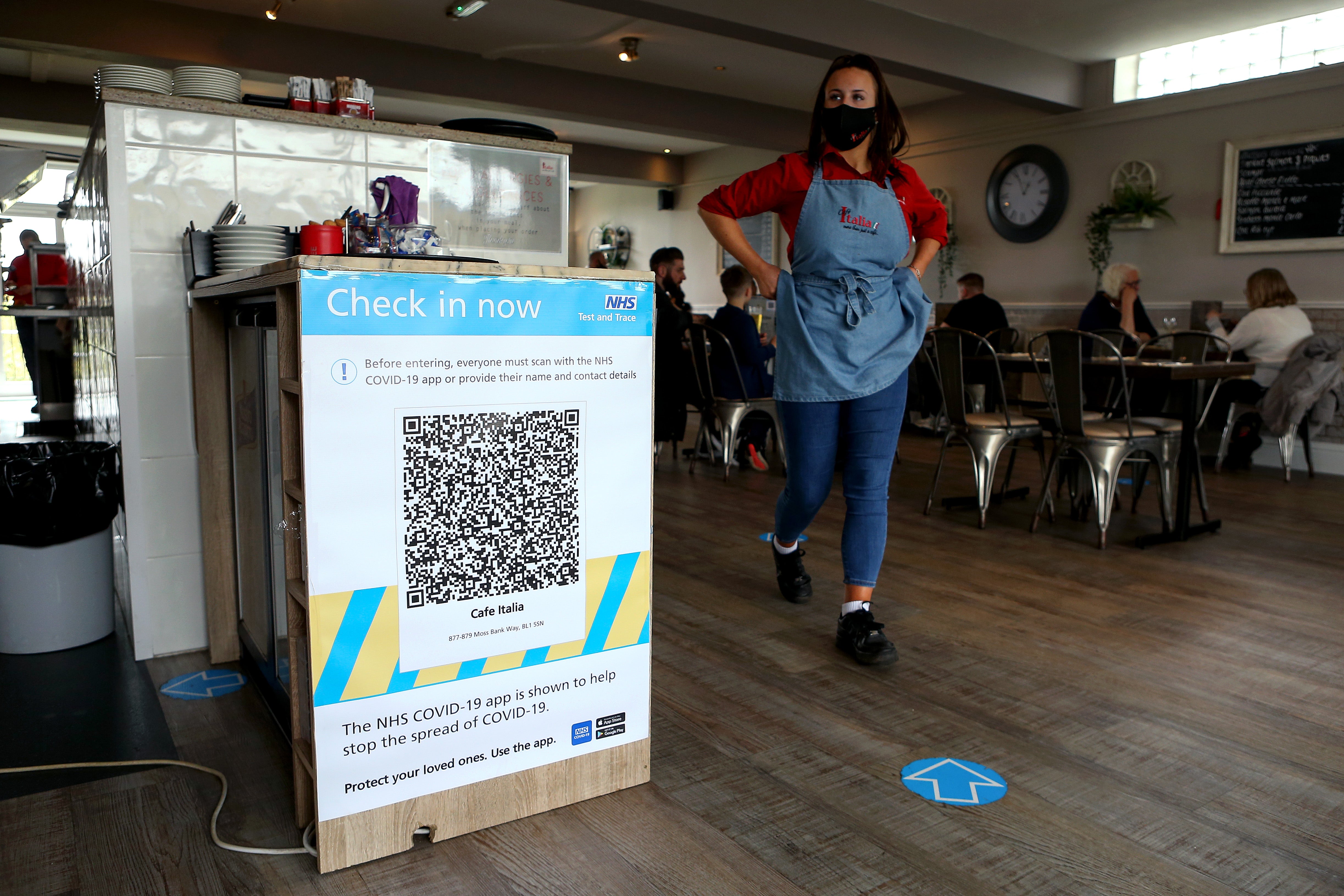 An NHS track and trace QR code is seen on a wall inside Cafe Italia as indoor hospitality returns, however, fears of new variants are mounting