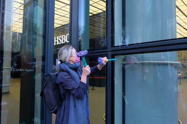 An Extinction Rebellion protester outside a branch of HSBC
