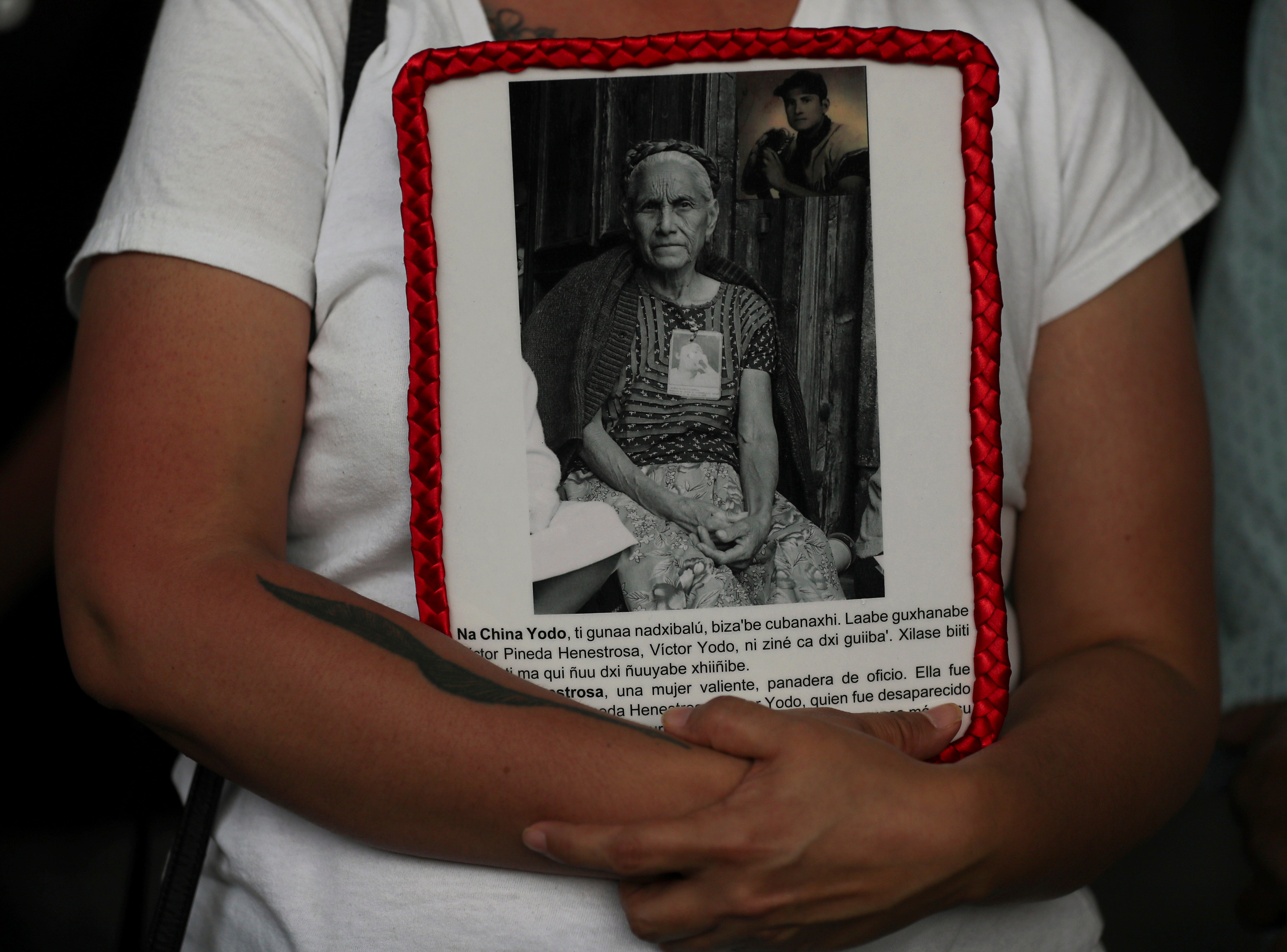 A person holds a portrait of a missing person during a protest outside of Mexico's General Prosecutor's office in Mexico City, Monday, May 10, 2021. The government says that over 80,000 people have disappeared in Mexico since the country's drug war began in 2006