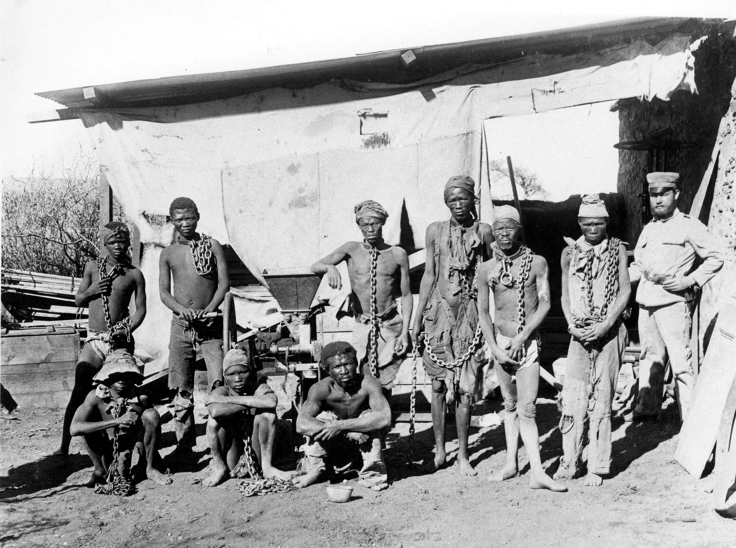 This undated photo, taken during the 1904-1908 genocide in Namibia, shows what is thought to be a German soldier supervising Namibian war prisoners