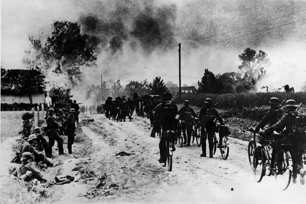 Nazi bicycle troops watch a soviet village burn during the invasion of Russia in October 1941