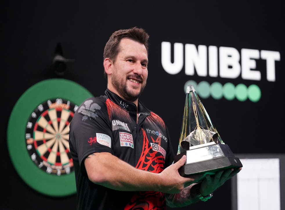 Jonny Clayton poses with the trophy after winning the Unibet Premier League final