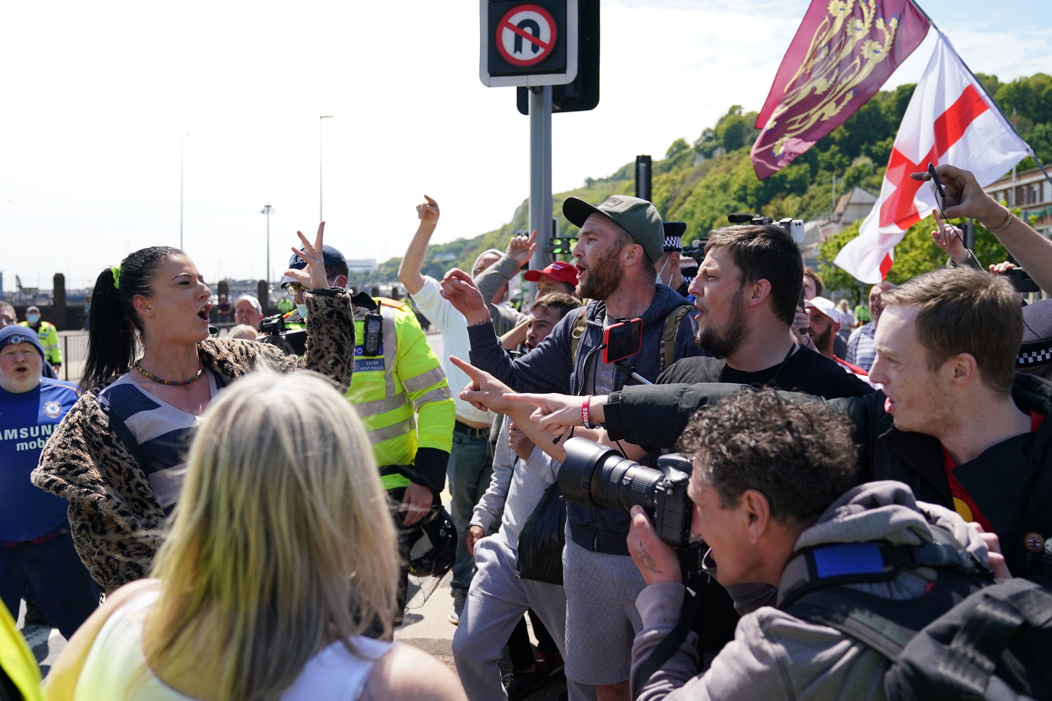 A woman airs her views in front of anti-migrant protesters in Dover