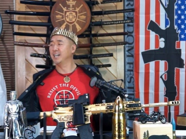 Hyung Jin “Sean” Moon, the leader of Sanctuary Church and Rod of Iron Ministries, delivers his “King’s Report” sermon from behind a golden AR-15