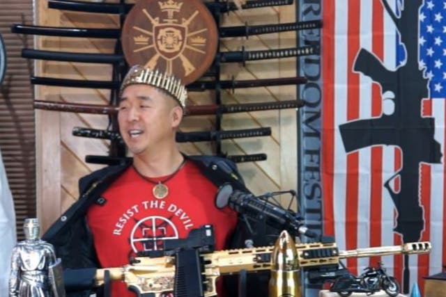 <p>Hyung Jin “Sean” Moon, the leader of Sanctuary Church and Rod of Iron Ministries, delivers his “King’s Report” sermon from behind  a golden AR-15</p>