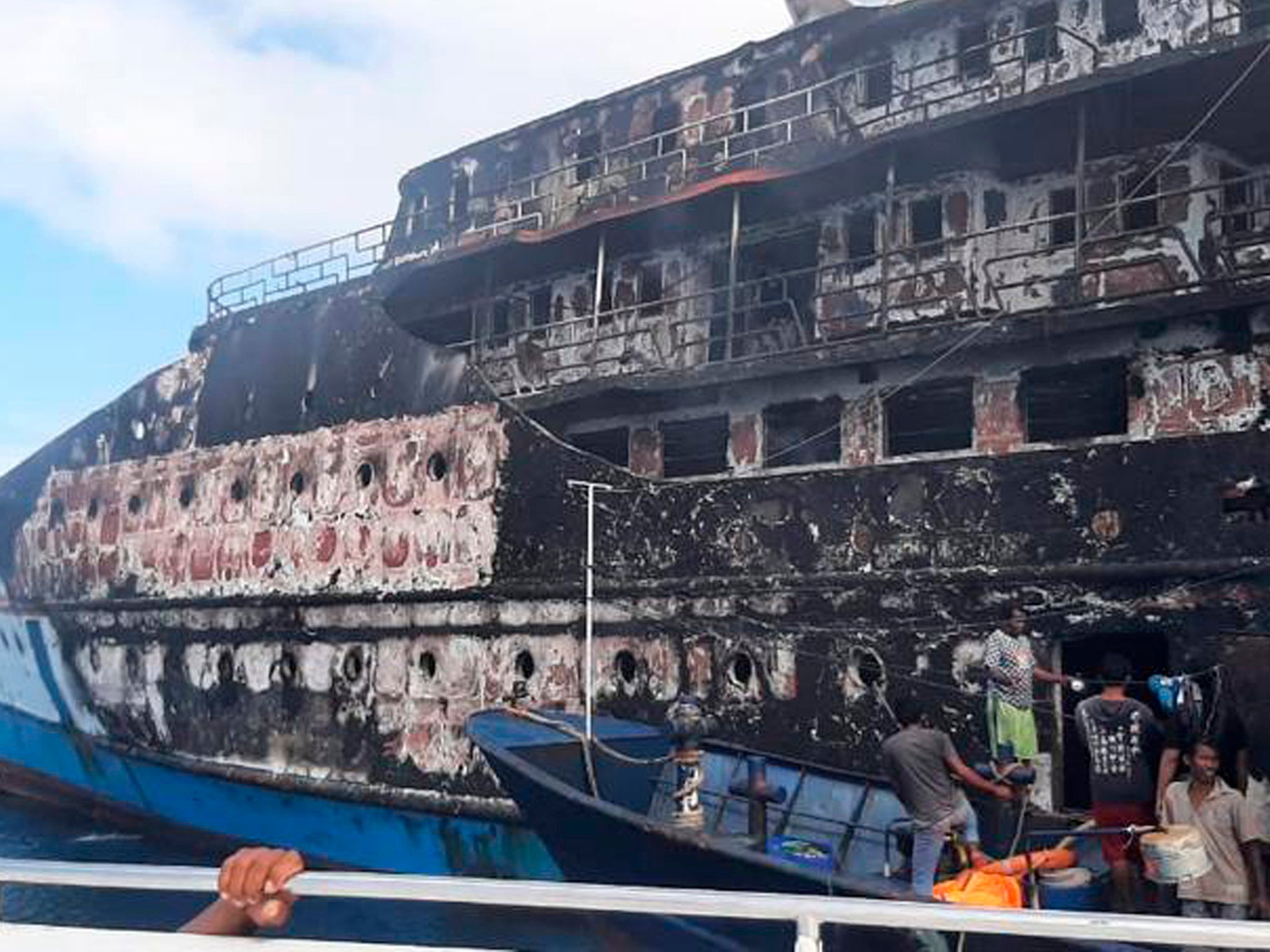 <p>Rescuers inspect the wreckage of KM Karya Indah after it caught fire off Limafatola Island, Indonesia</p>