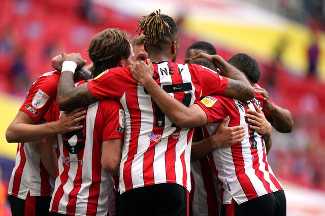 <p>Brentford celebrate their second goal at Wembley from Emiliano Marcondes, hidden</p>