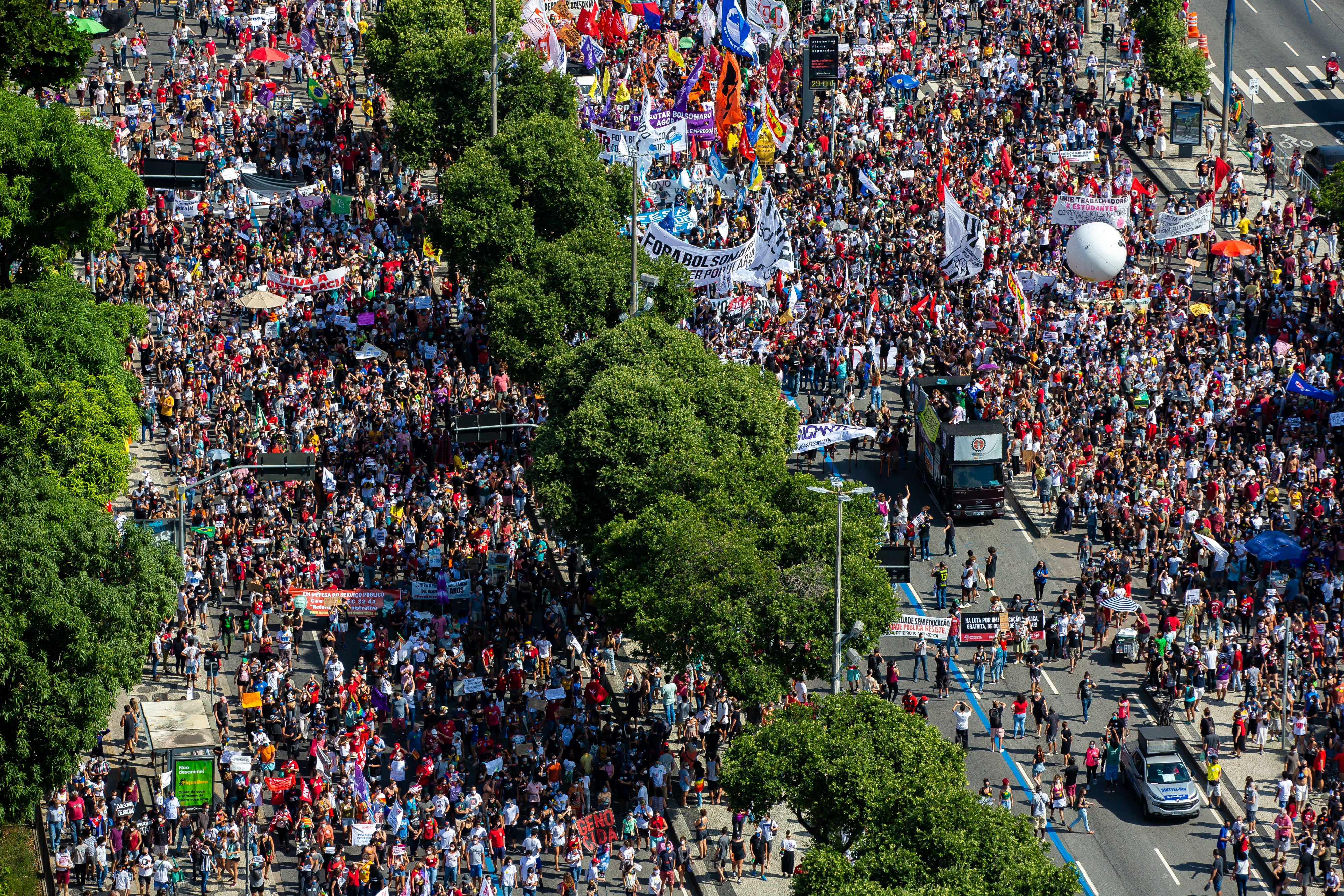 RIO DE JANEIRO, BRAZIL - MAY 29: Demonstrators gather with flags and signs during a protest against Brazilian President Jair Bolsonaro at Avenida Presidente Vargas on 29 May, 2021 in Rio de Janeiro, Brazil.