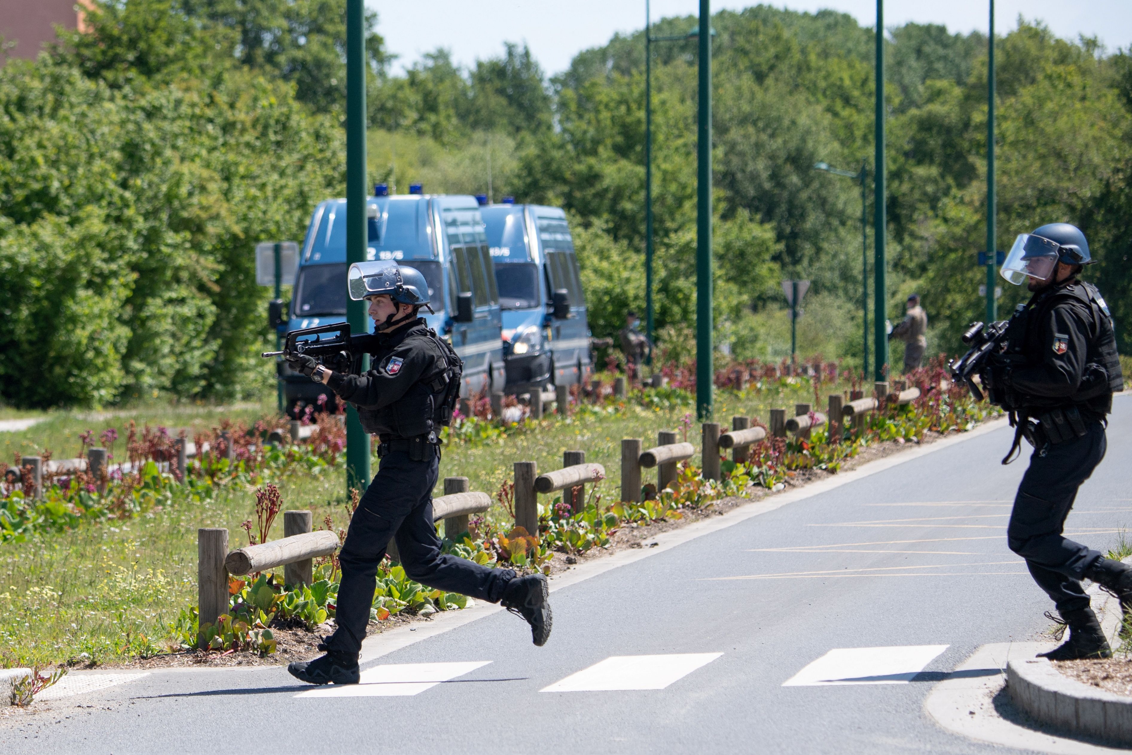 Members of the National Gendarmerie Intervention Group (GIGN) inspect the site where a suspect has been seen after a municipal policewoman was attacked with a knife on 28 May, 2021. A major search is underway in France’s Dordogne region for a man accused of shooting at law enforcement.