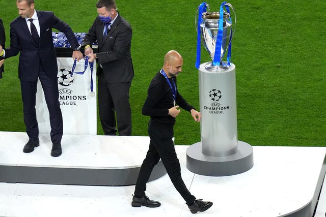 Pep Guardiola is forced to walk past the trophy