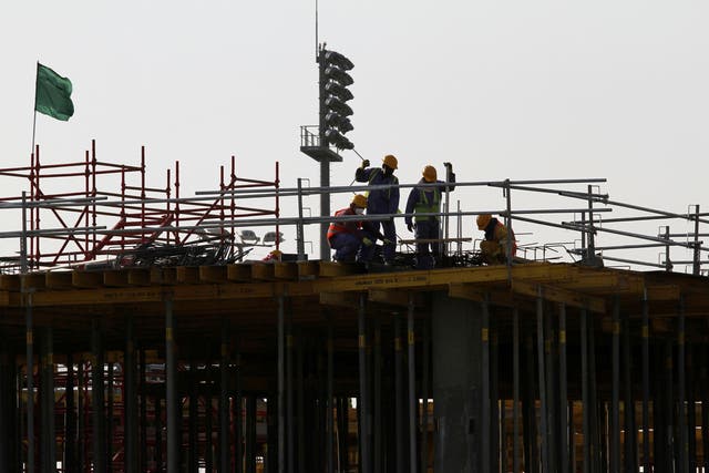 <p>Migrant labourers work at a construction site at the Aspire Zone in Doha</p>