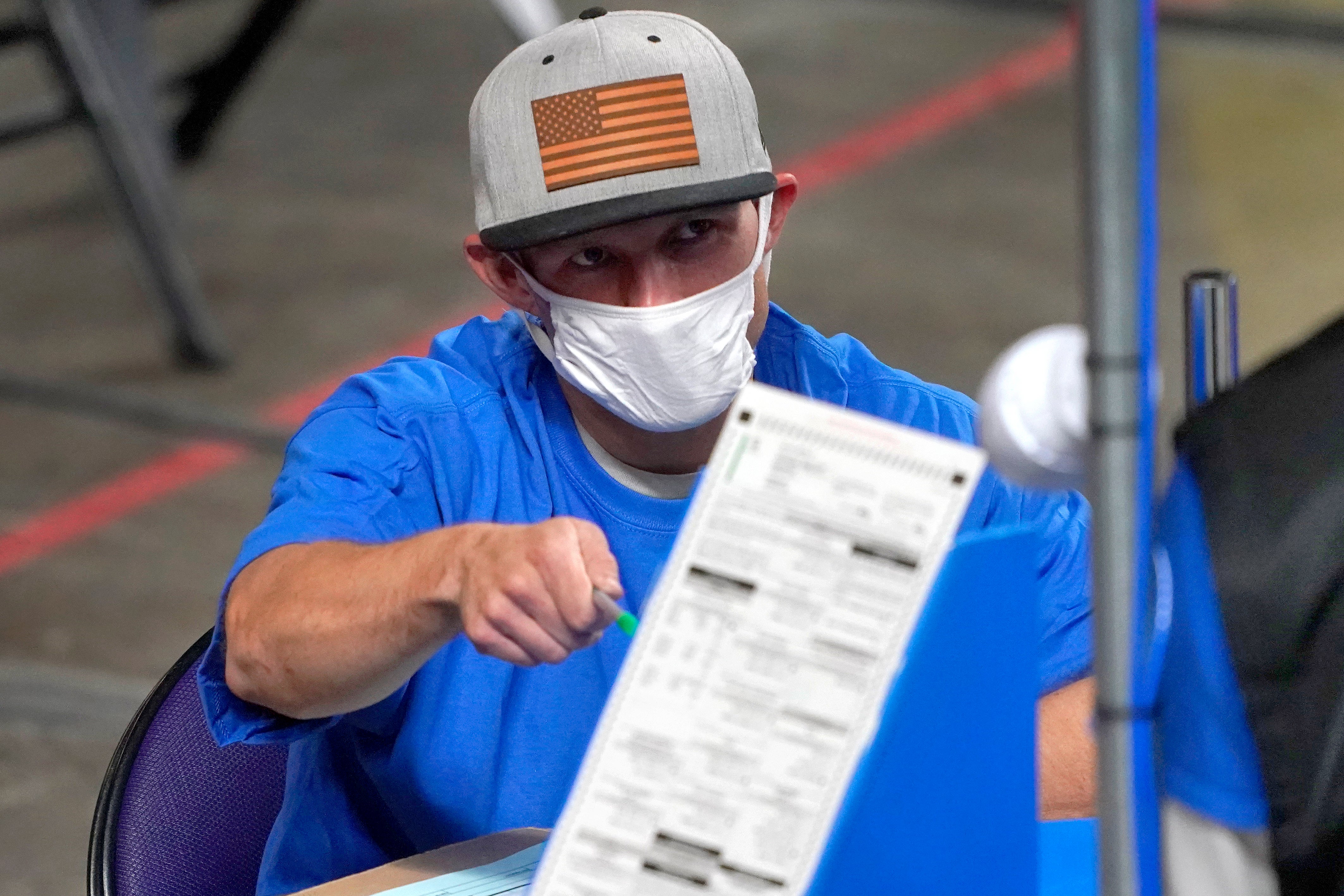 A volunteer hand recounts votes in Maricopa County, Arizona