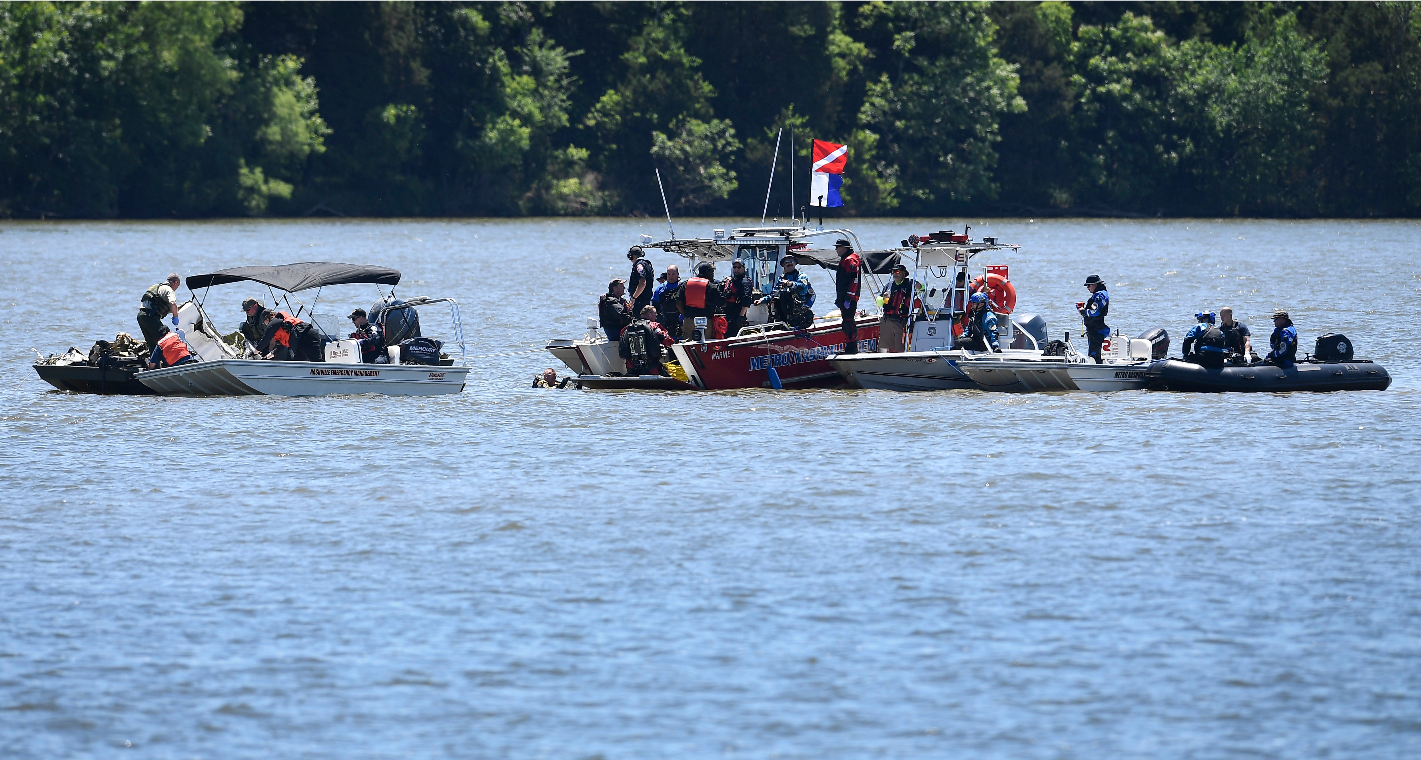 Emergency personnel remove debris from a plane crash in Percy Priest Lake Sunday, 30 May, 2021, near Smyrna, Tennessee. A small jet carrying seven people crashed Saturday, and authorities indicated that no one on board survived